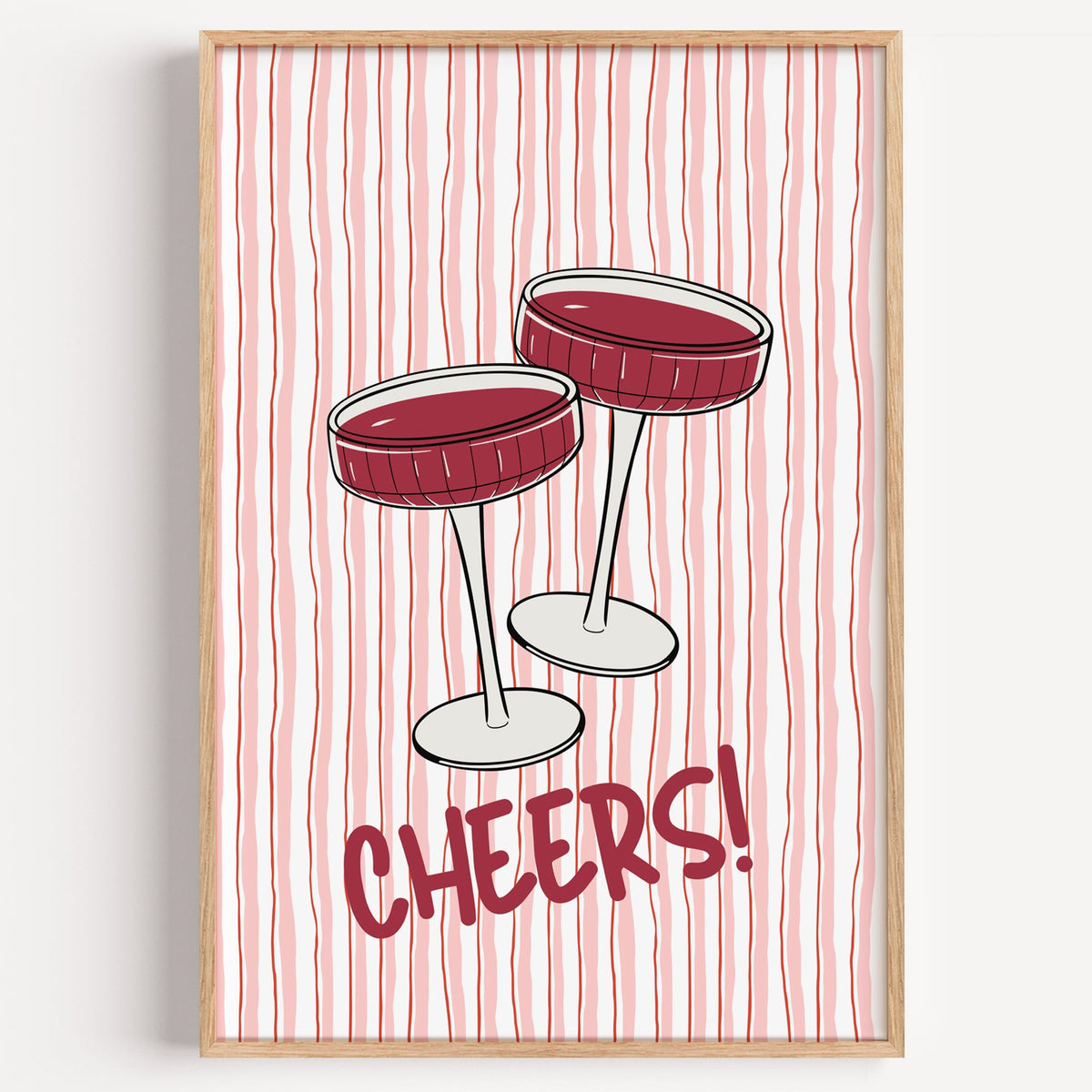 Cheers coupes pink stripe print in a light oak frame on a plain white wall