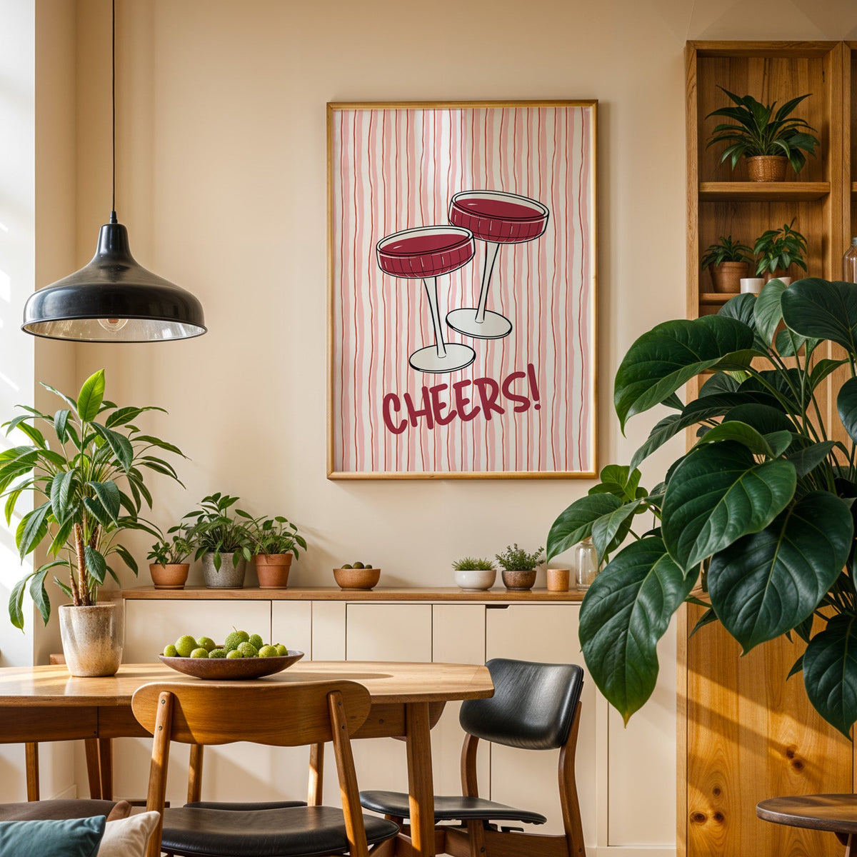 Cheers coupes print in an oak frame in a dining room above a plant-lined sideboard