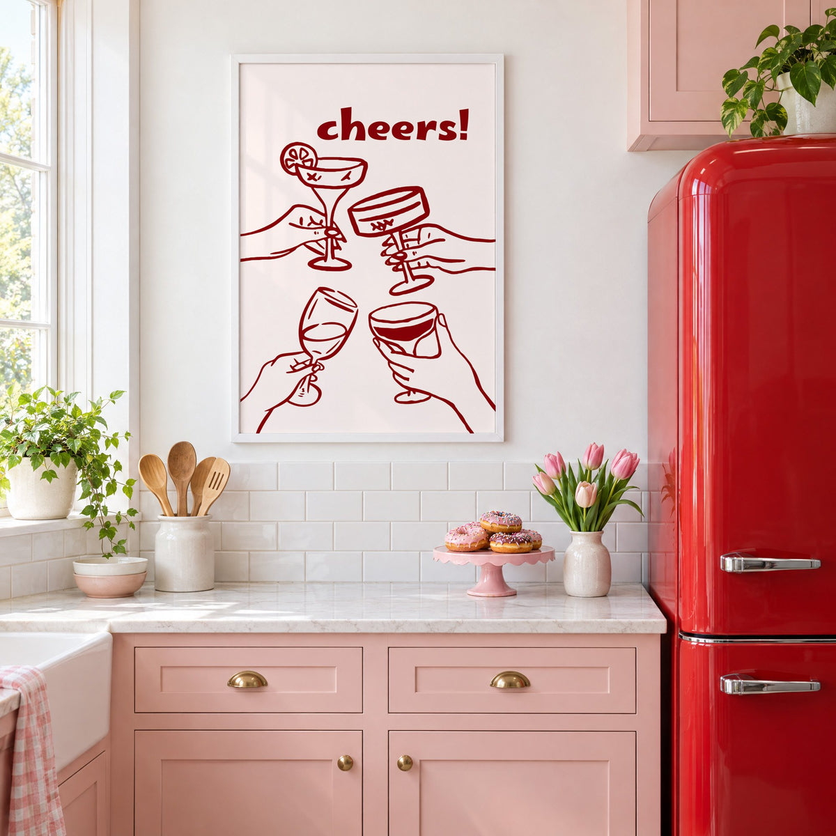 cheers! four hands toasting burgundy line print in a white frame above pink cabinets beside a red retro fridge