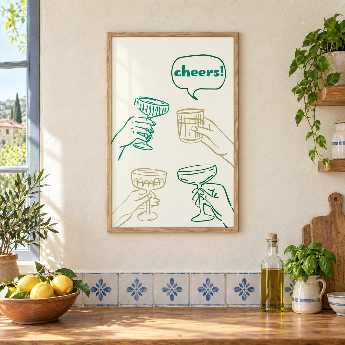 cheers! hands toasting coupes teal and gold print in an oak frame on a cream plaster wall above a worktop with a bowl of lemons and blue-and-white tiles