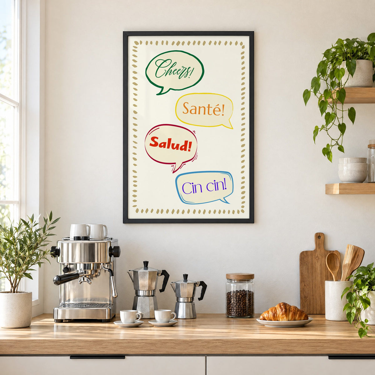 Cheers! Santé! Salud! Cin cin! speech bubbles print in a black frame above a home espresso bar with moka pots and espresso cups
