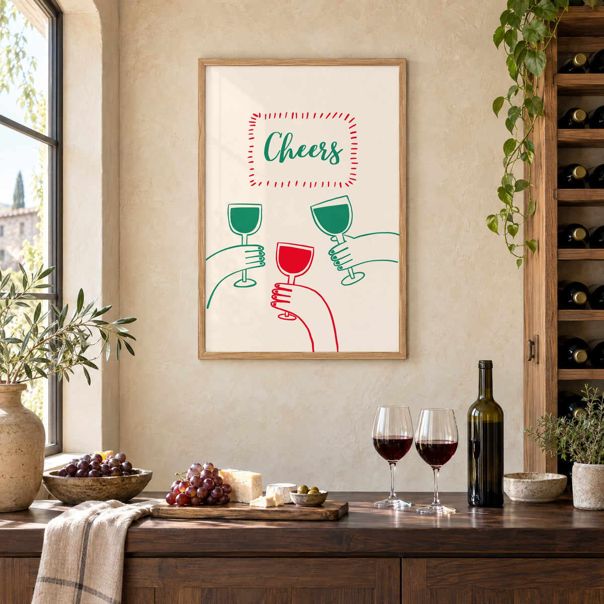 Cheers three hands wine toast line print in an oak frame on a limewashed wall above a wine counter with red wine, cheese and grapes