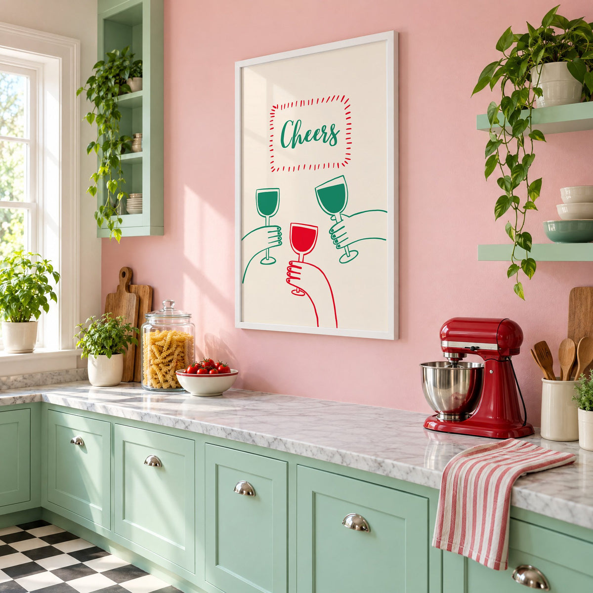 Cheers three hands wine toast line print in a white frame on a pink wall above mint green cabinets in a retro kitchen, seen at an angle