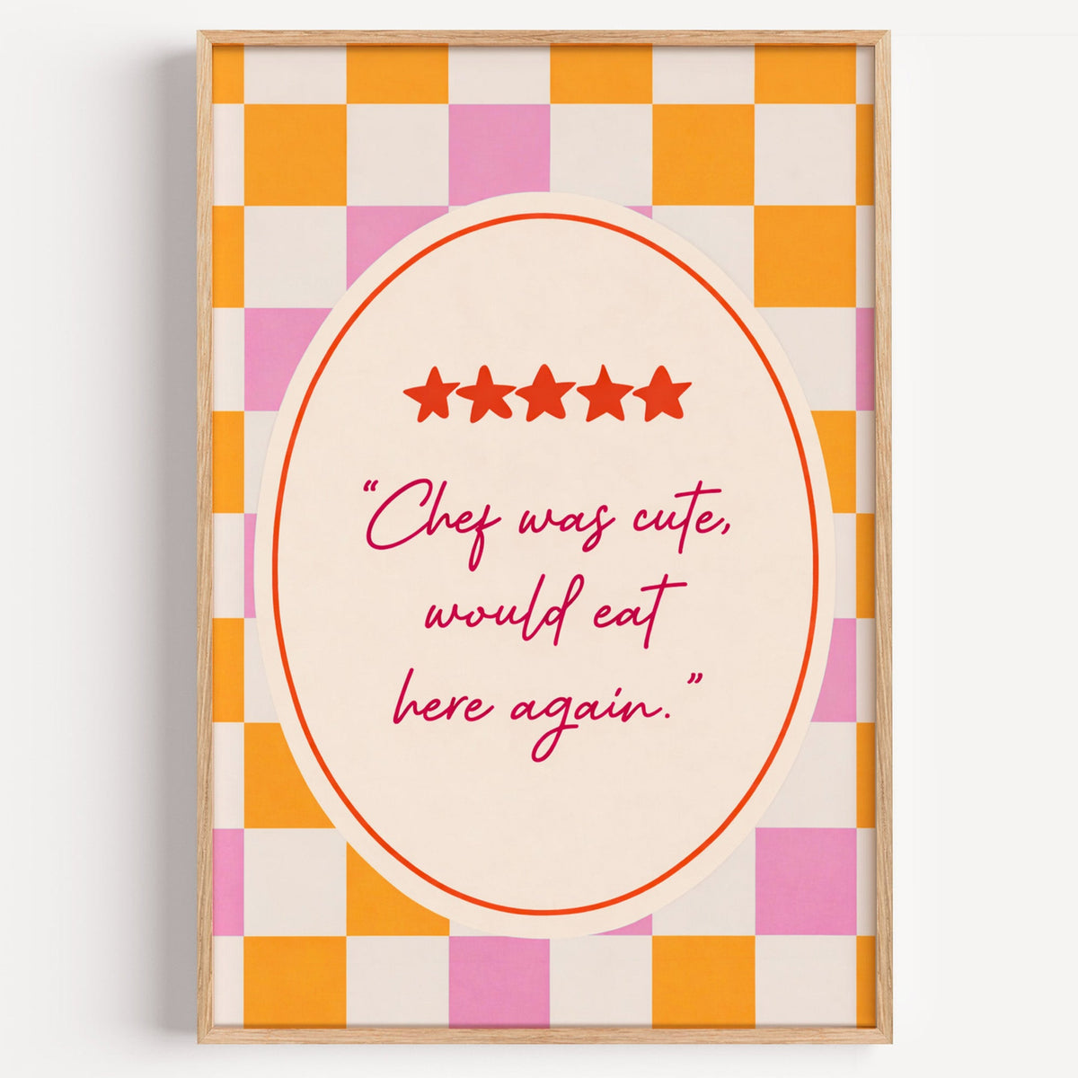 Chef Was Cute checkerboard quote print in a light oak frame on a plain white wall