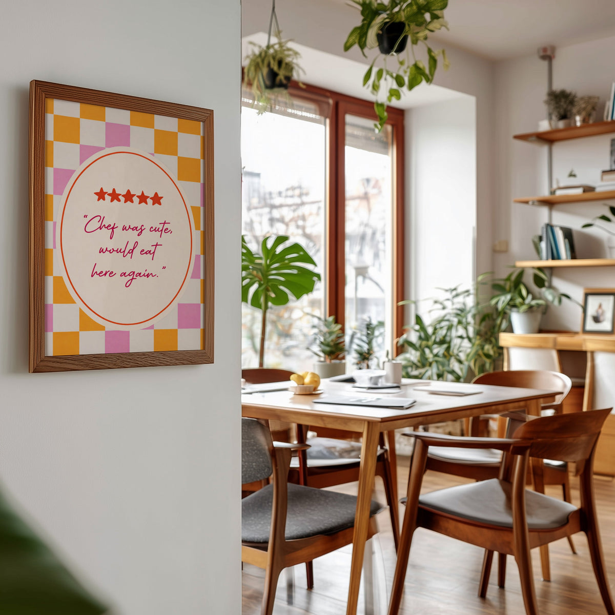 Chef Was Cute print in a walnut frame beside a mid-century dining table