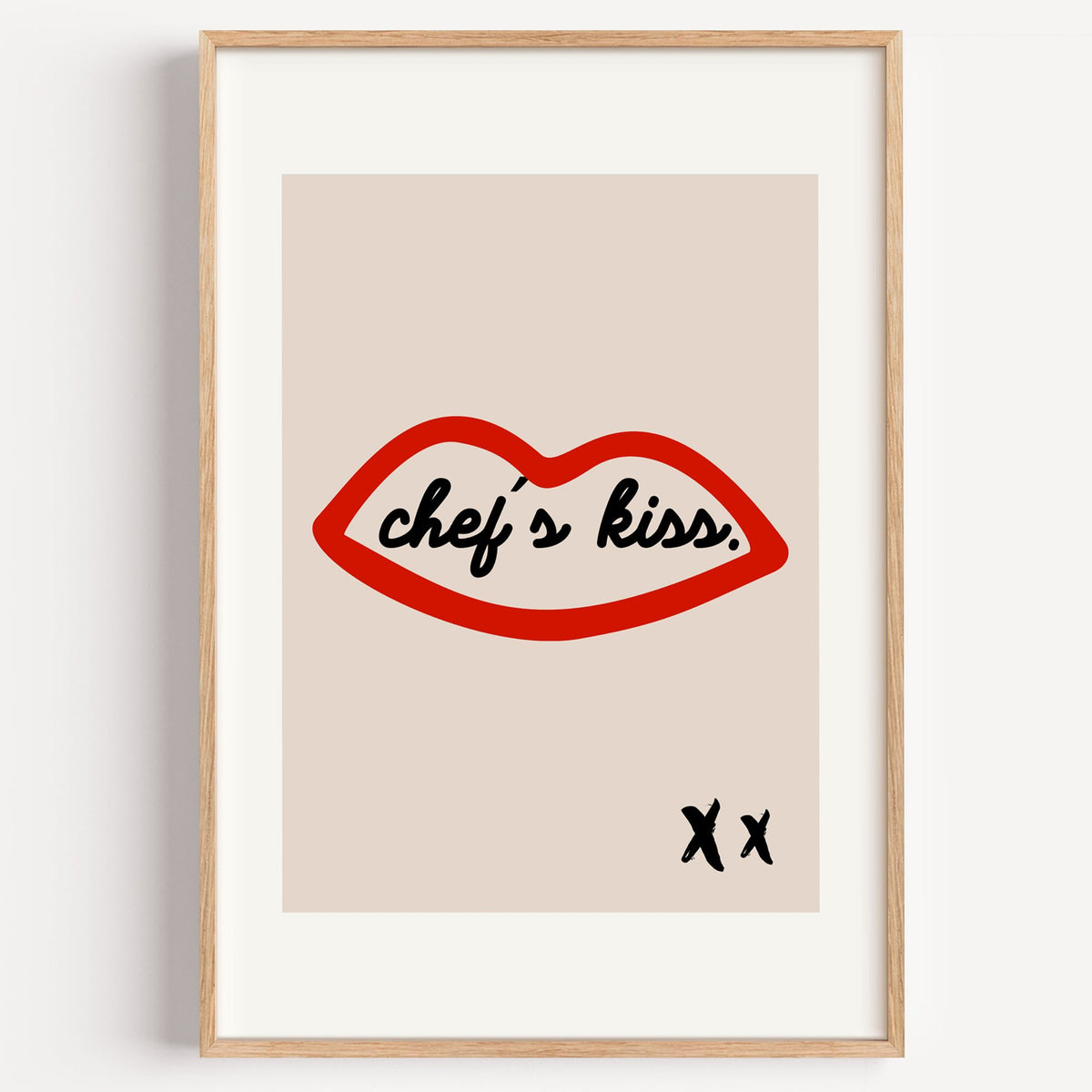 Chef's kiss red lips outline print in a light oak frame on a plain white wall