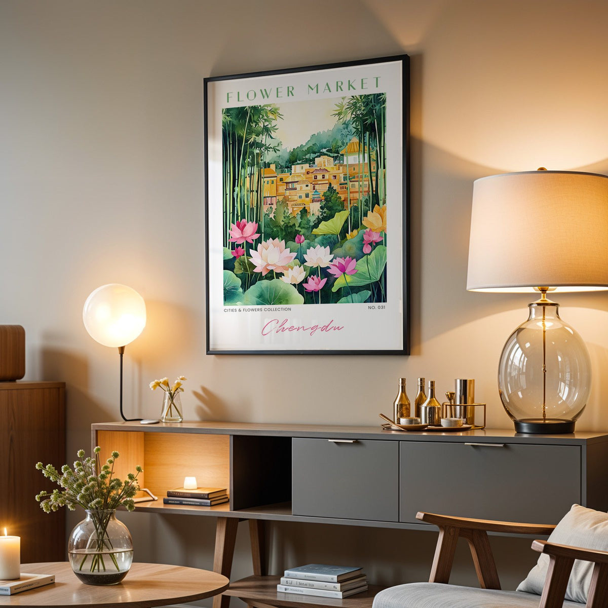 Chengdu flower market print in a black frame above a grey media console with a glass table lamp