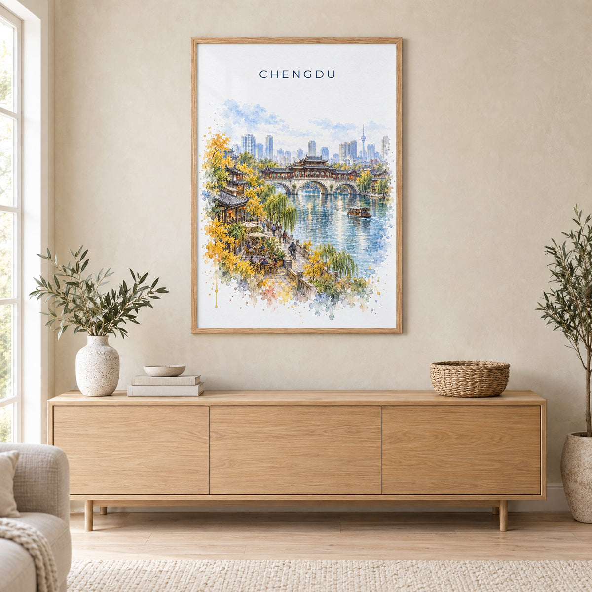 Chengdu watercolor print in an oak frame above a light wood sideboard in a Scandinavian living room