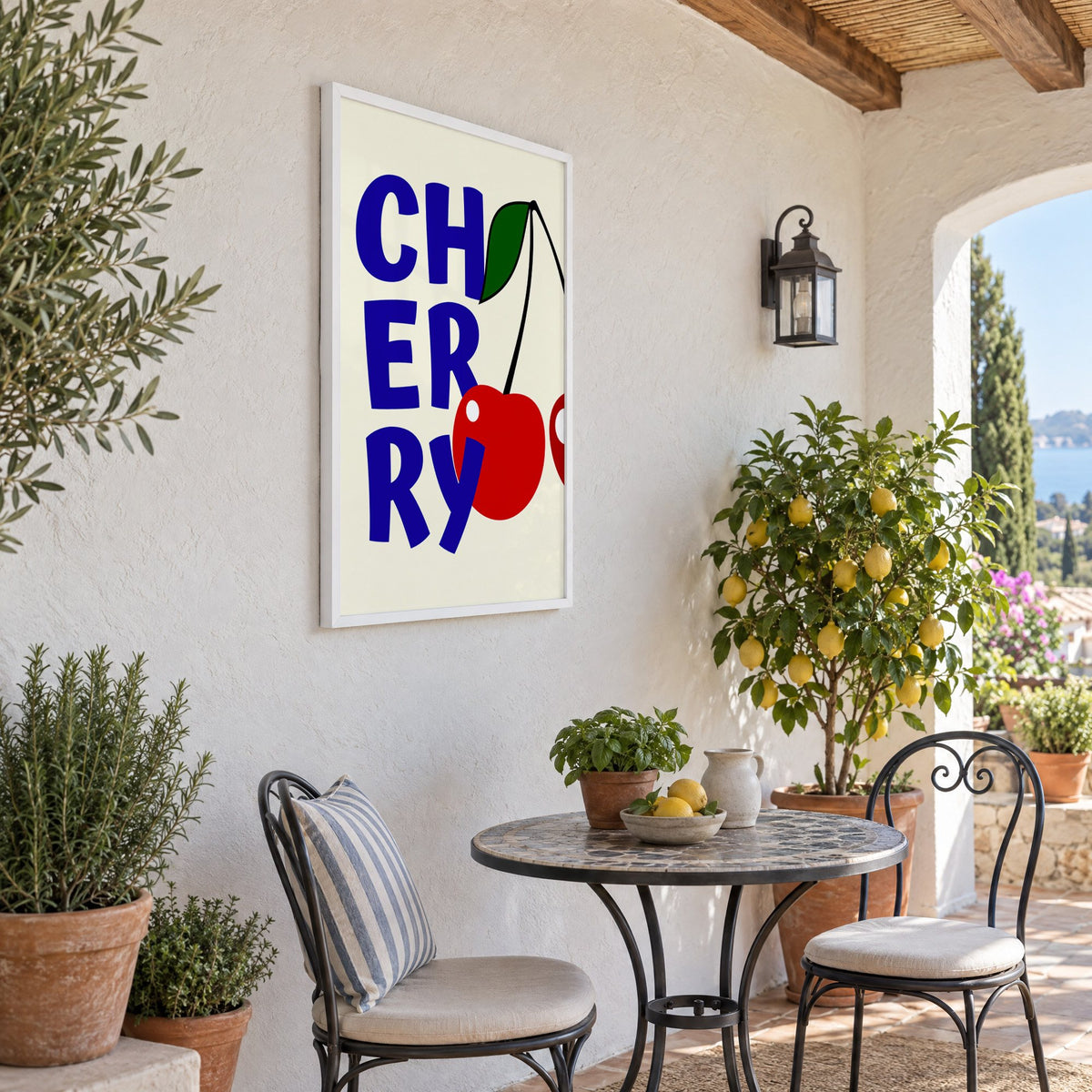 Cherry bold navy letters print in a white frame on a sunny patio wall beside a potted lemon tree