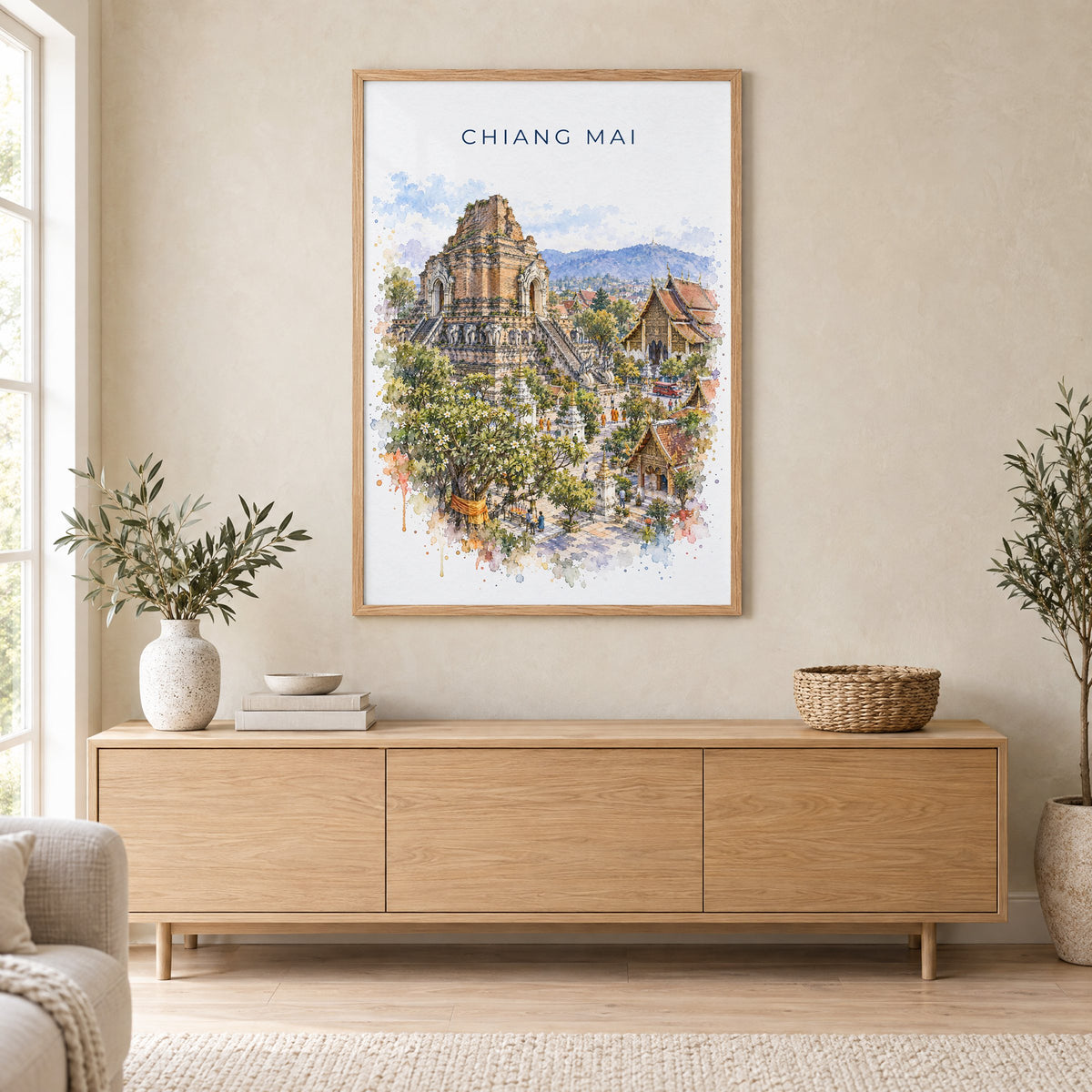 Chiang Mai watercolor print in an oak frame above a light wood sideboard in a Scandinavian living room