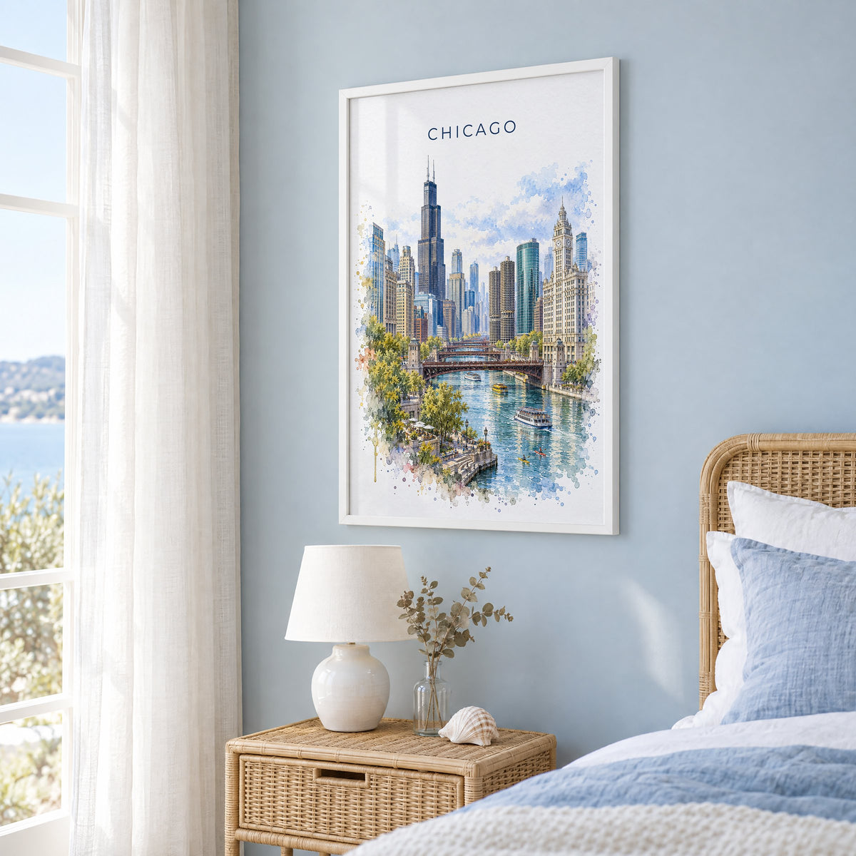 Chicago watercolor print in a white frame on a pale blue wall beside a rattan bed in a coastal bedroom