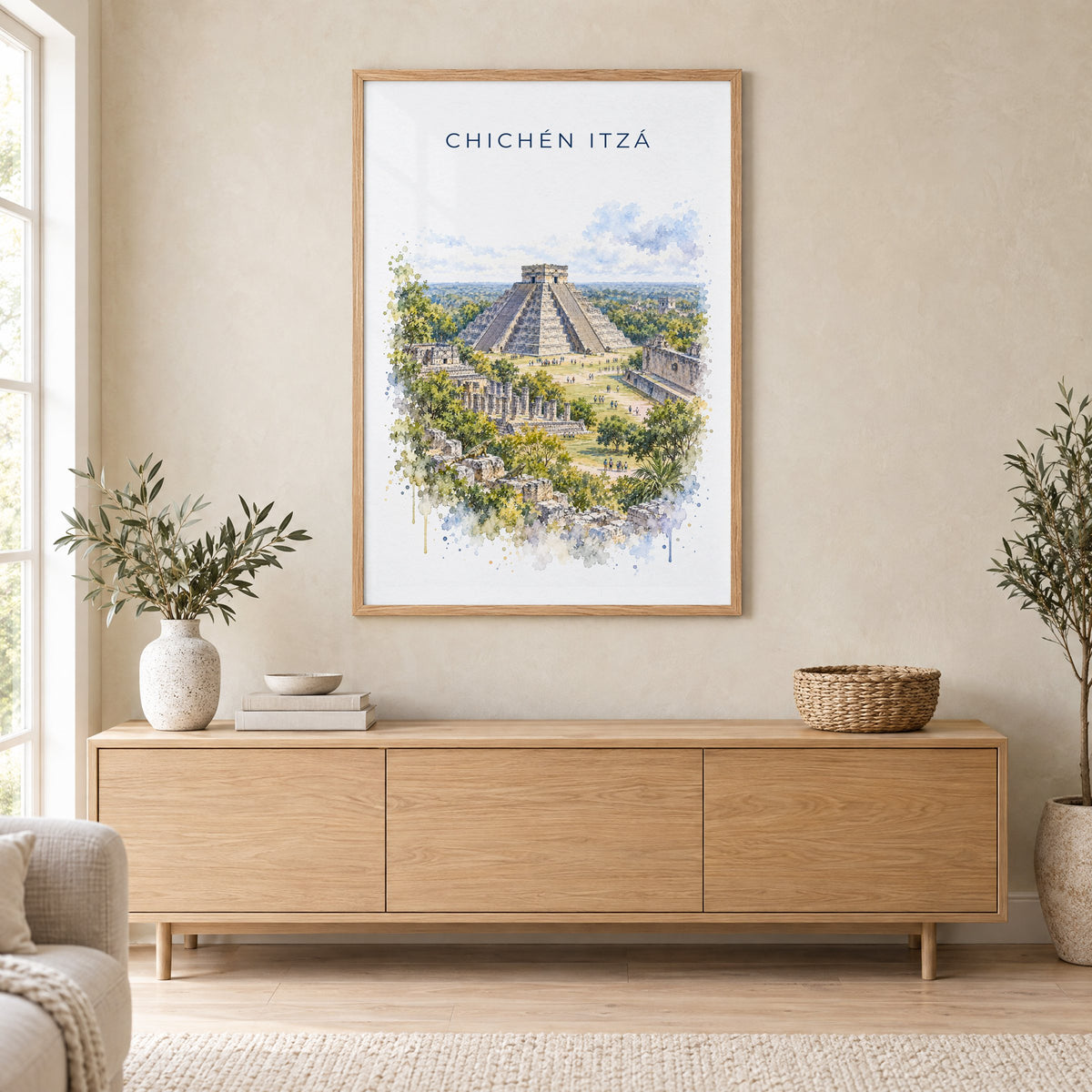 Chichen Itza watercolor print in an oak frame above a light wood sideboard in a Scandinavian living room