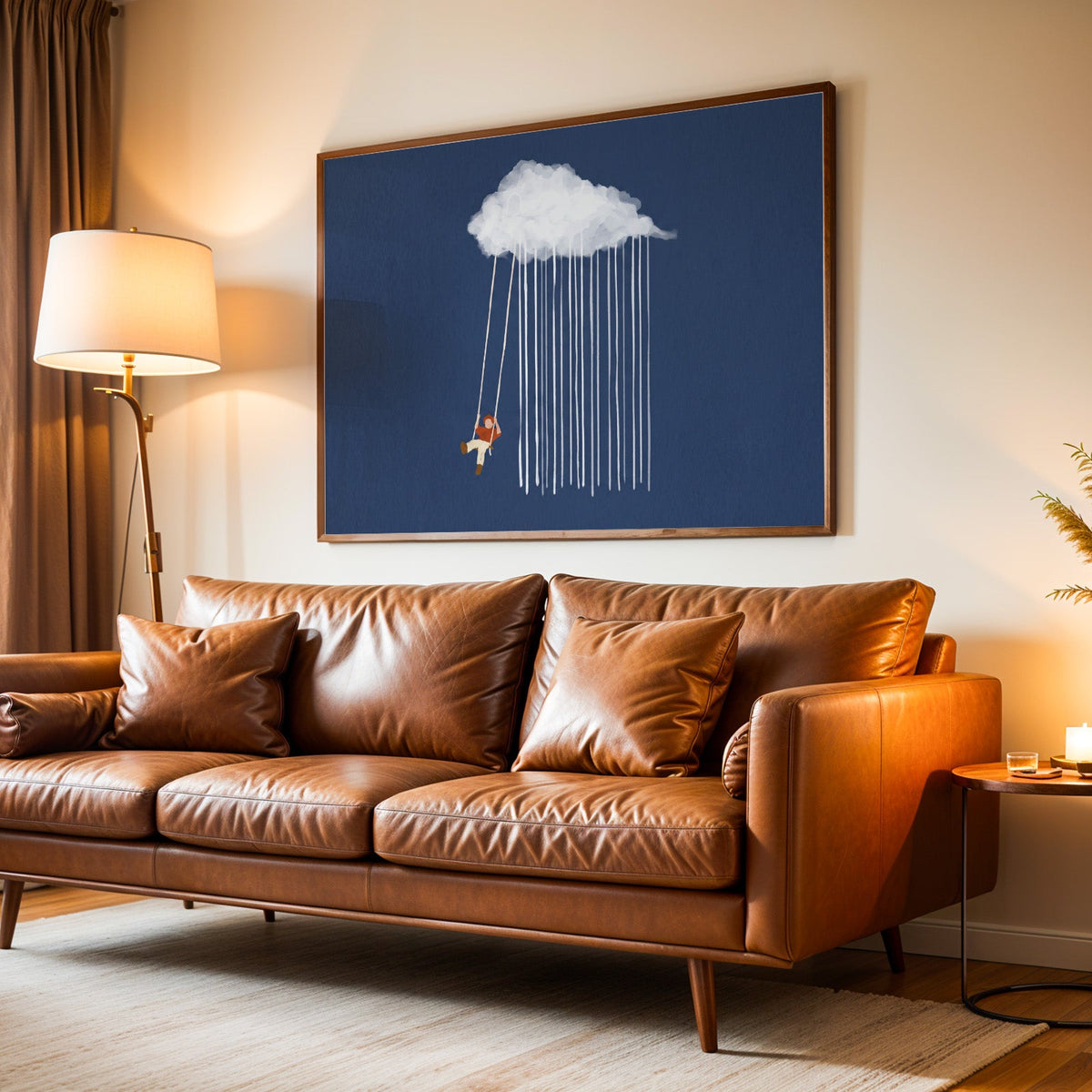 Nursery cloud swing print in a walnut frame above a leather sofa by lamplight
