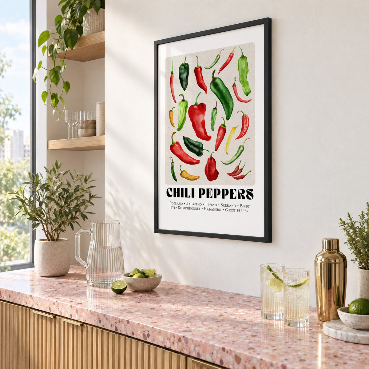 CHILI PEPPERS watercolor varieties print in a black frame above a pink terrazzo cocktail counter with limes, seen at an angle