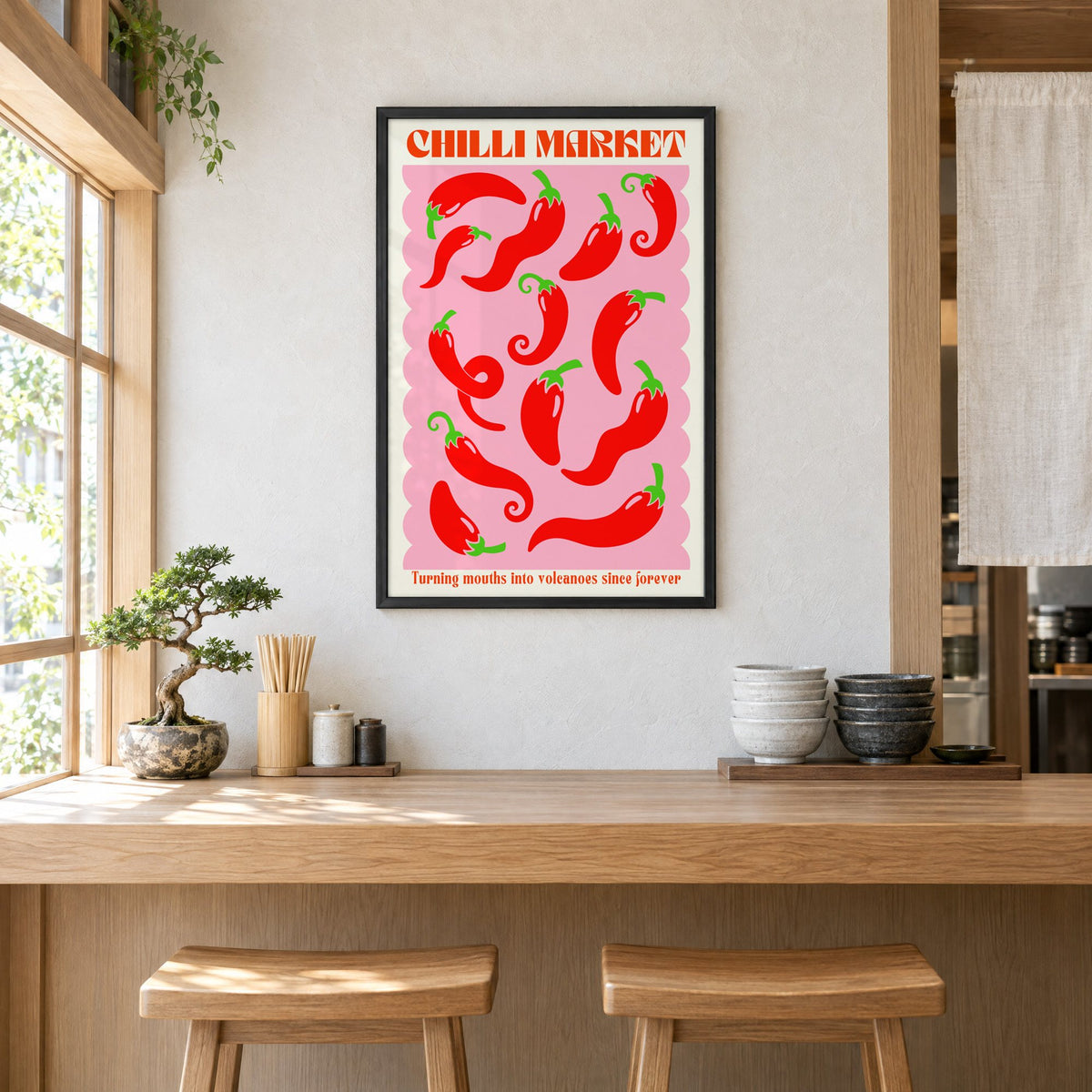 CHILLI MARKET red peppers pink scallop print in a black frame above a light wood ramen counter with stools and stacked bowls