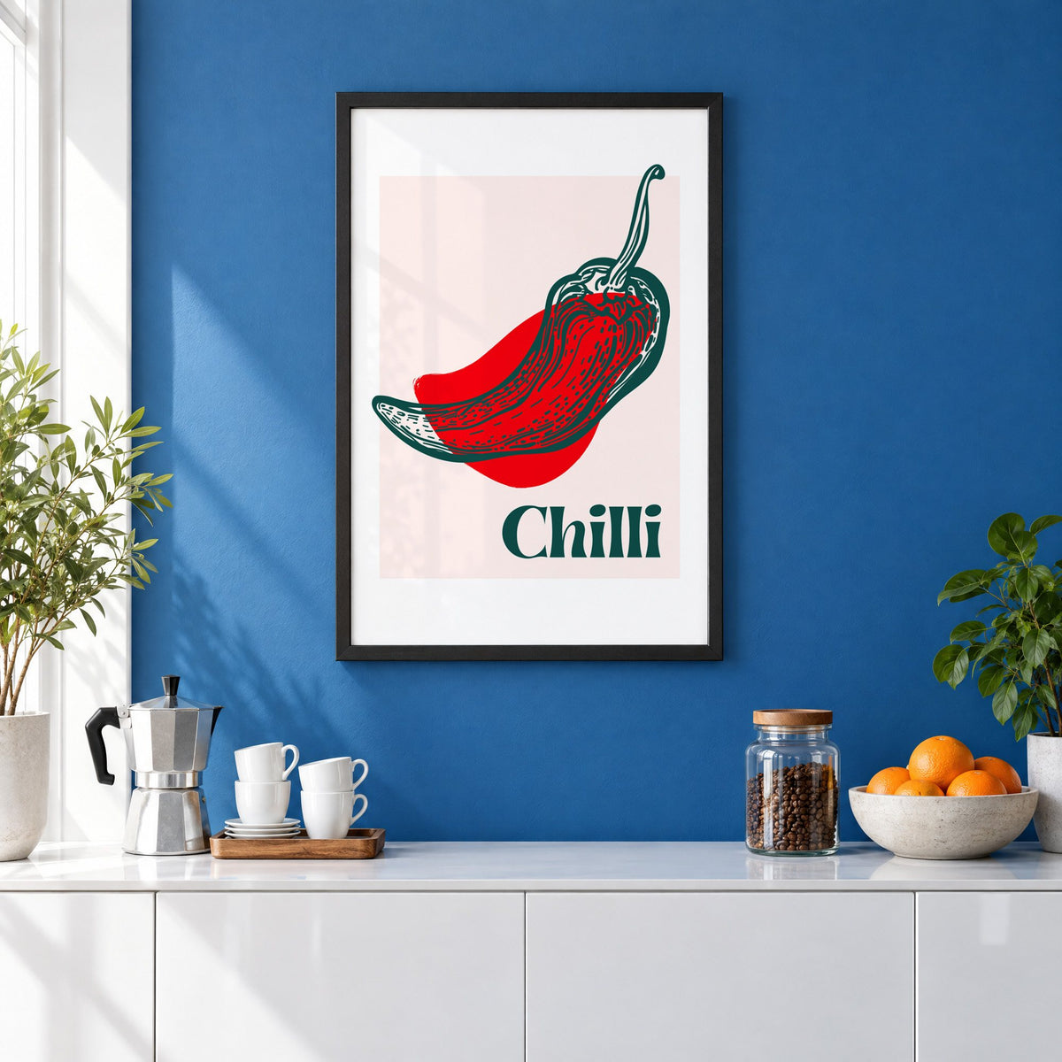 Chilli red pepper sketch print in a black frame on a cobalt blue wall above a coffee station