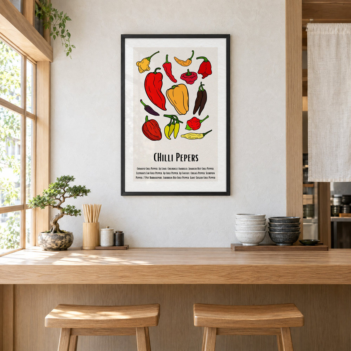 CHilli Pepers bold outline pepper chart print in a black frame above a light wood ramen counter with stools and stacked bowls