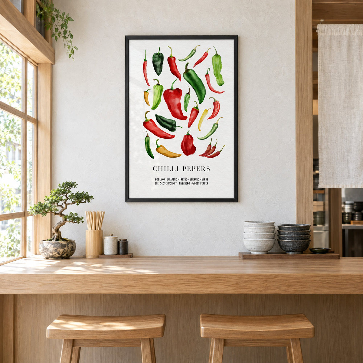 CHILLI PEPERS watercolor pepper varieties print in a black frame above a light wood ramen counter with stools and stacked bowls
