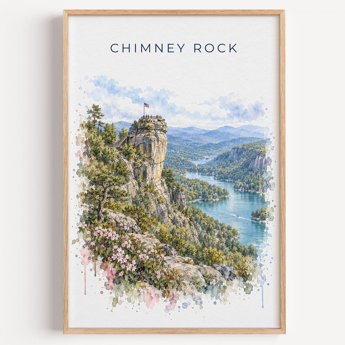 Chimney Rock, North Carolina watercolor print in a light oak frame on a plain white wall