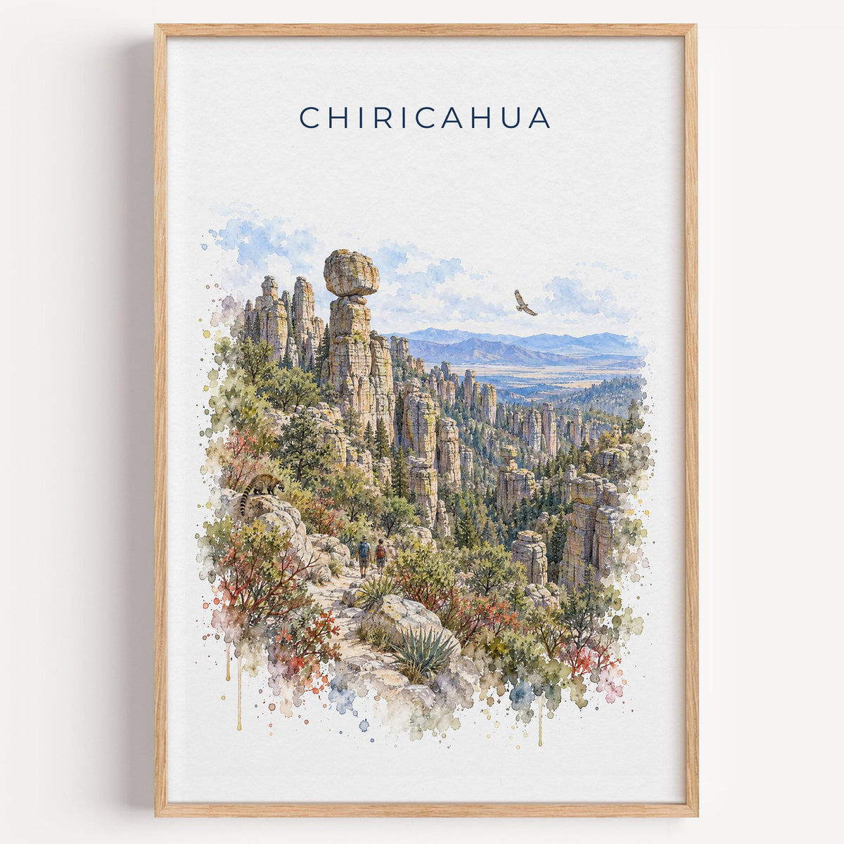 Chiricahua National Park watercolor print in a light oak frame on a plain white wall