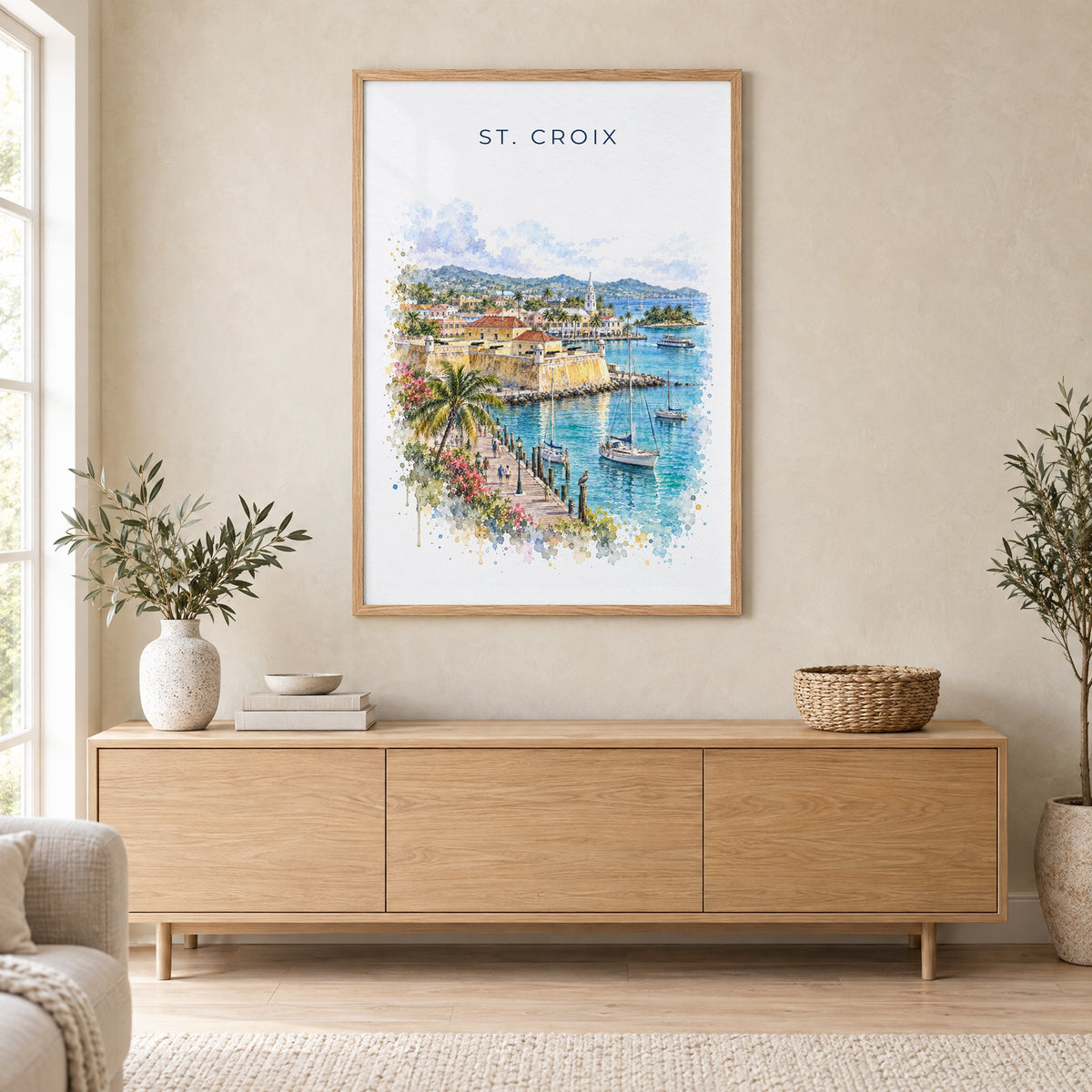 St. Croix watercolor print in an oak frame above a light wood sideboard in a Scandinavian living room