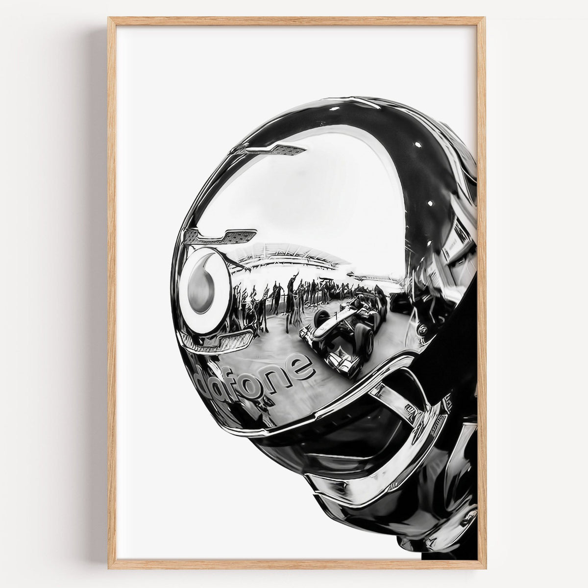 Chrome racing helmet with reflected race cars print in a light oak frame on a plain white wall