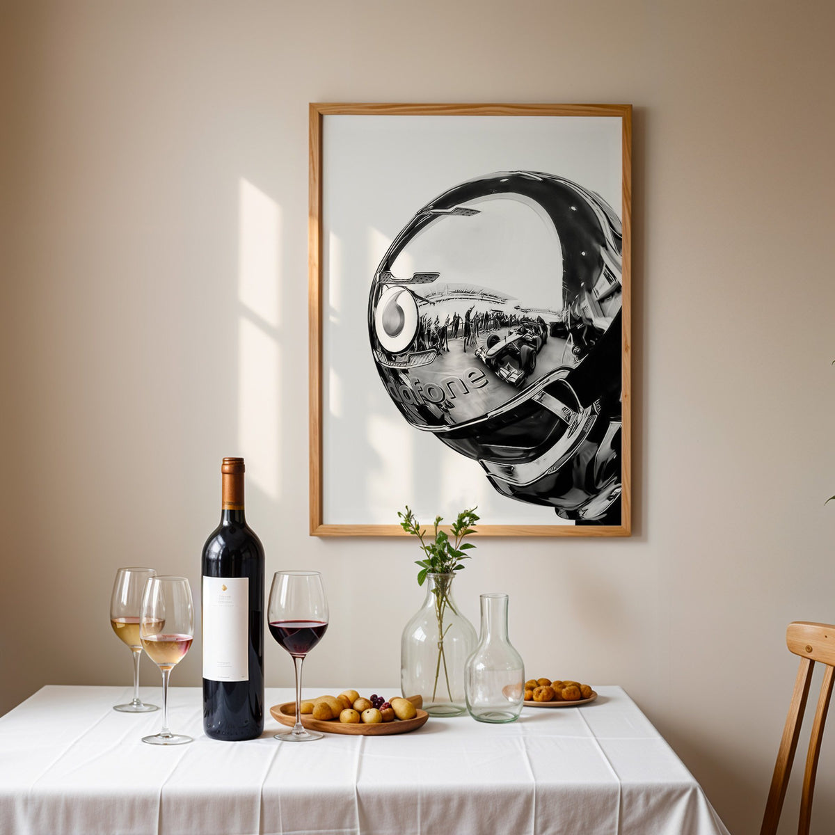 Chrome racing helmet with reflected race cars print in an oak frame above a table set with red wine and glasses