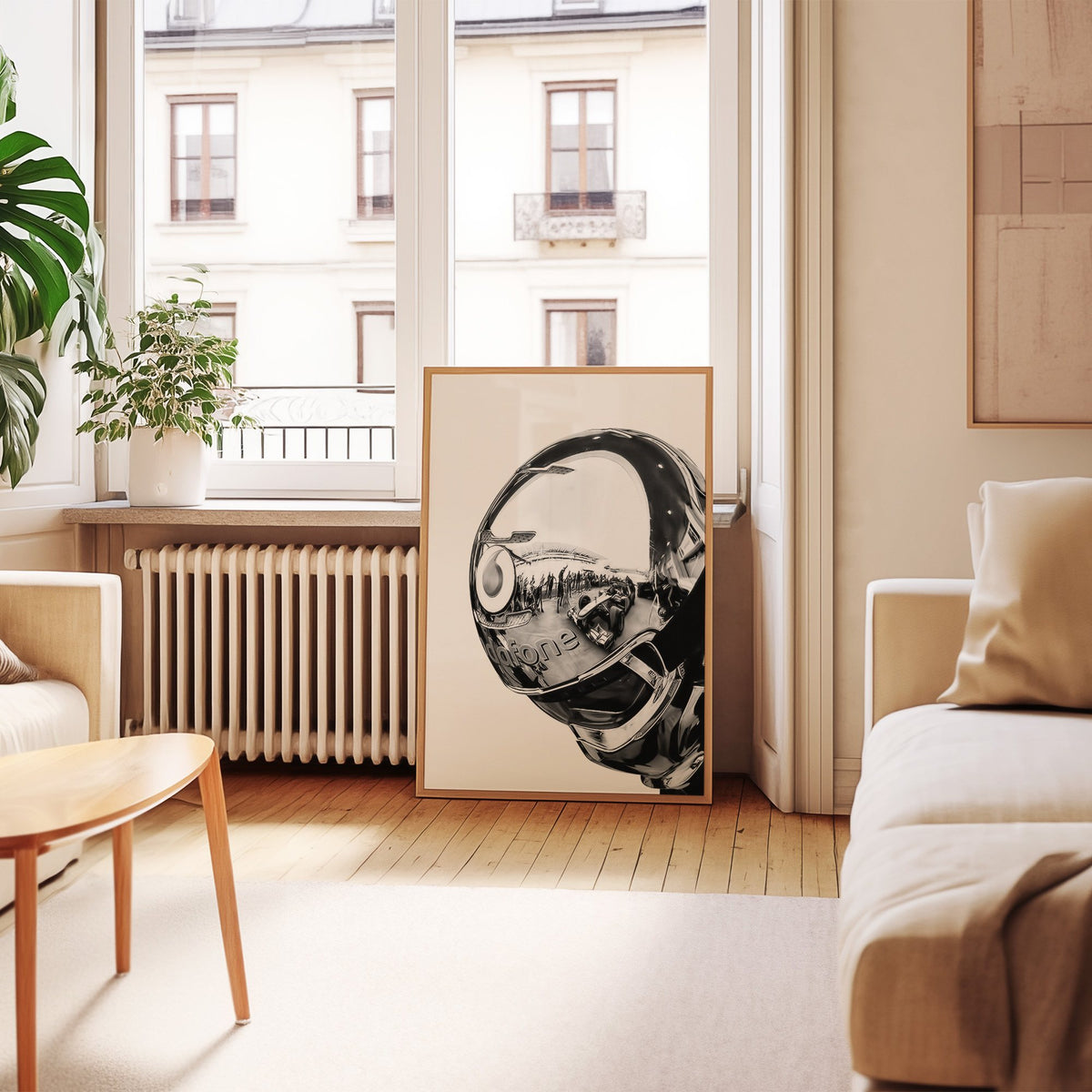 Chrome racing helmet with reflected race cars print in an oak frame leaning by a French window in a living room