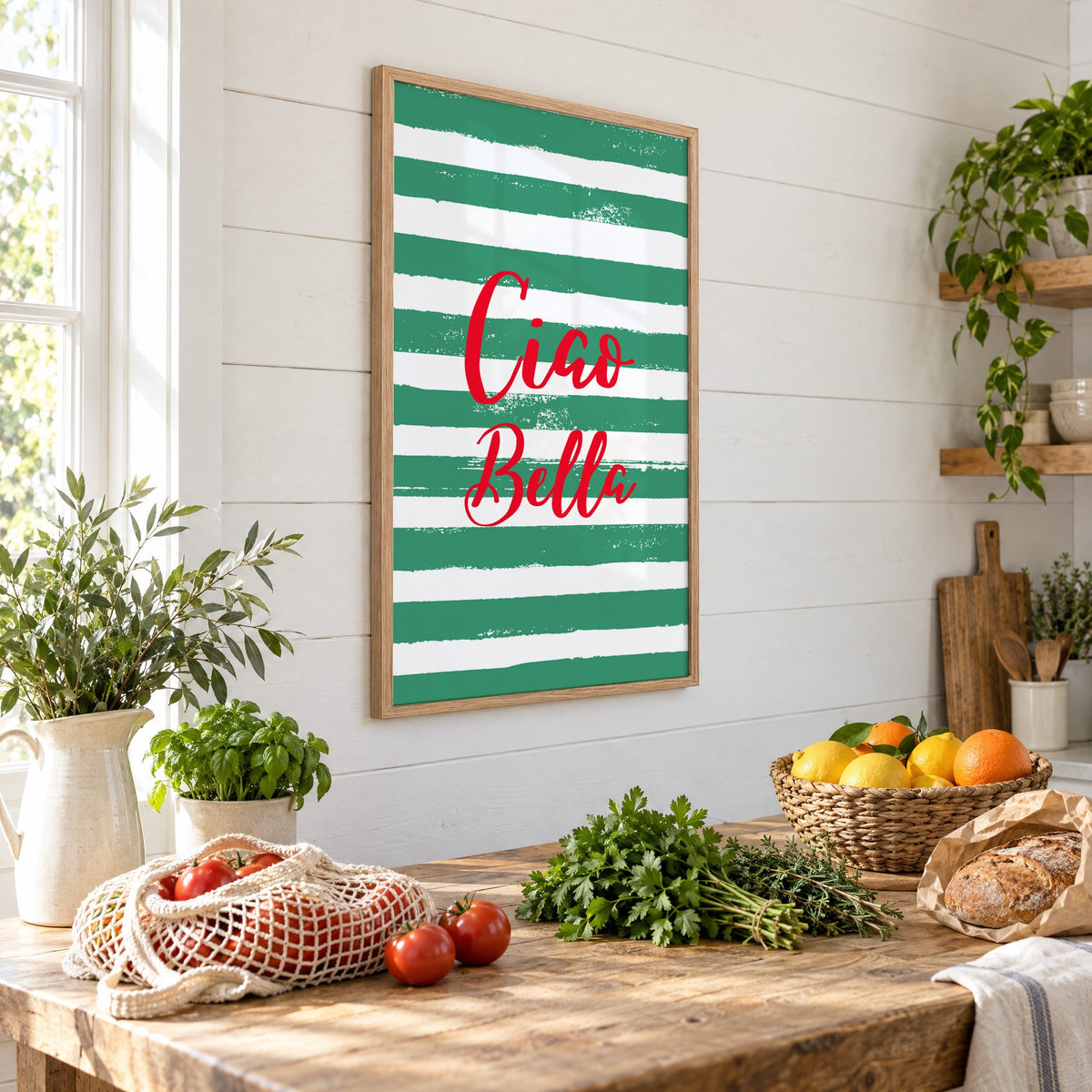 Ciao Bella red script on green stripes print in an oak frame on a shiplap wall above a farm table with market tomatoes and citrus, seen at an angle
