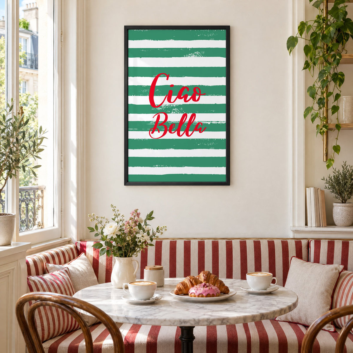 Ciao Bella red script on green stripes print in a black frame above a striped cafe breakfast nook with cappuccino and pastries