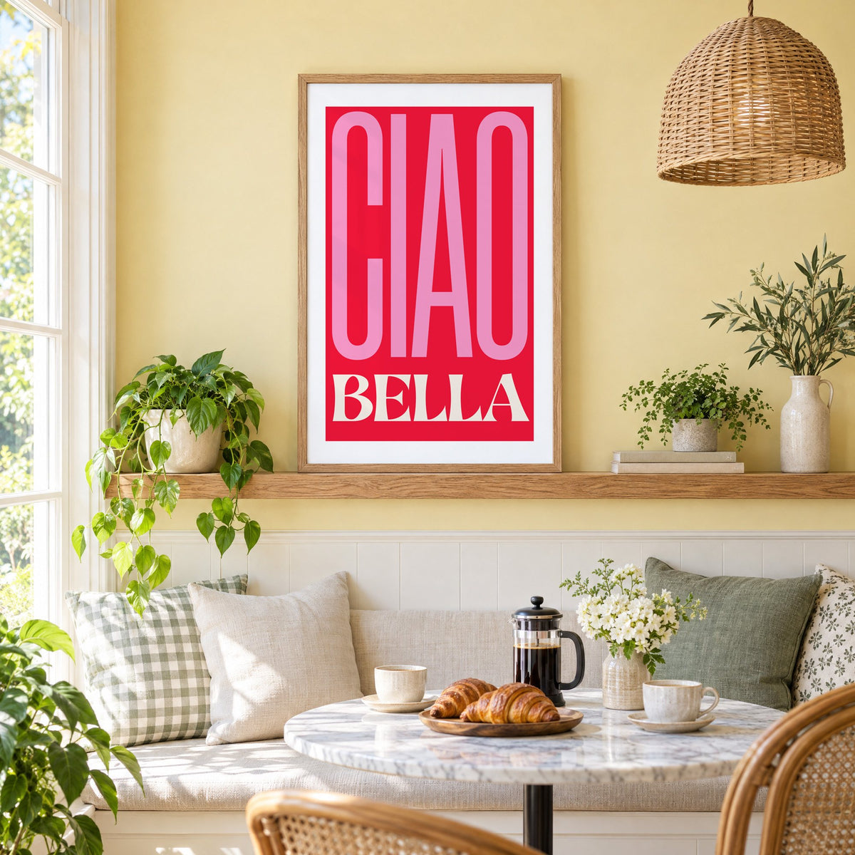 Ciao Bella pink and red type print in an oak frame on a picture ledge above a sunny breakfast nook