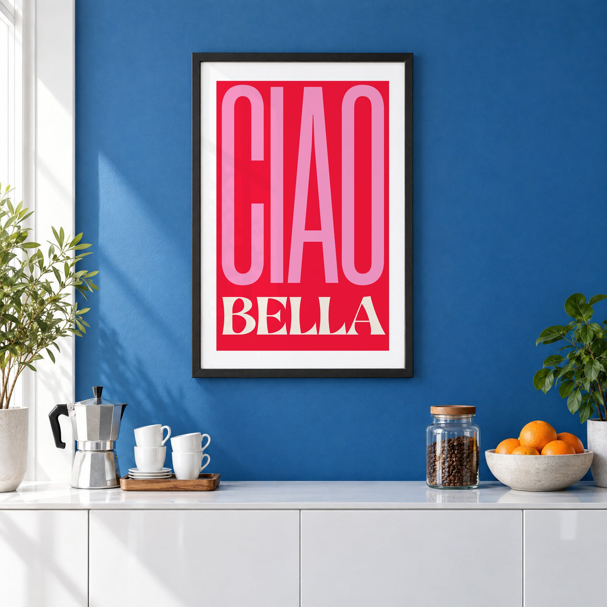 Ciao Bella pink and red type print in a black frame on a cobalt blue wall above a coffee station