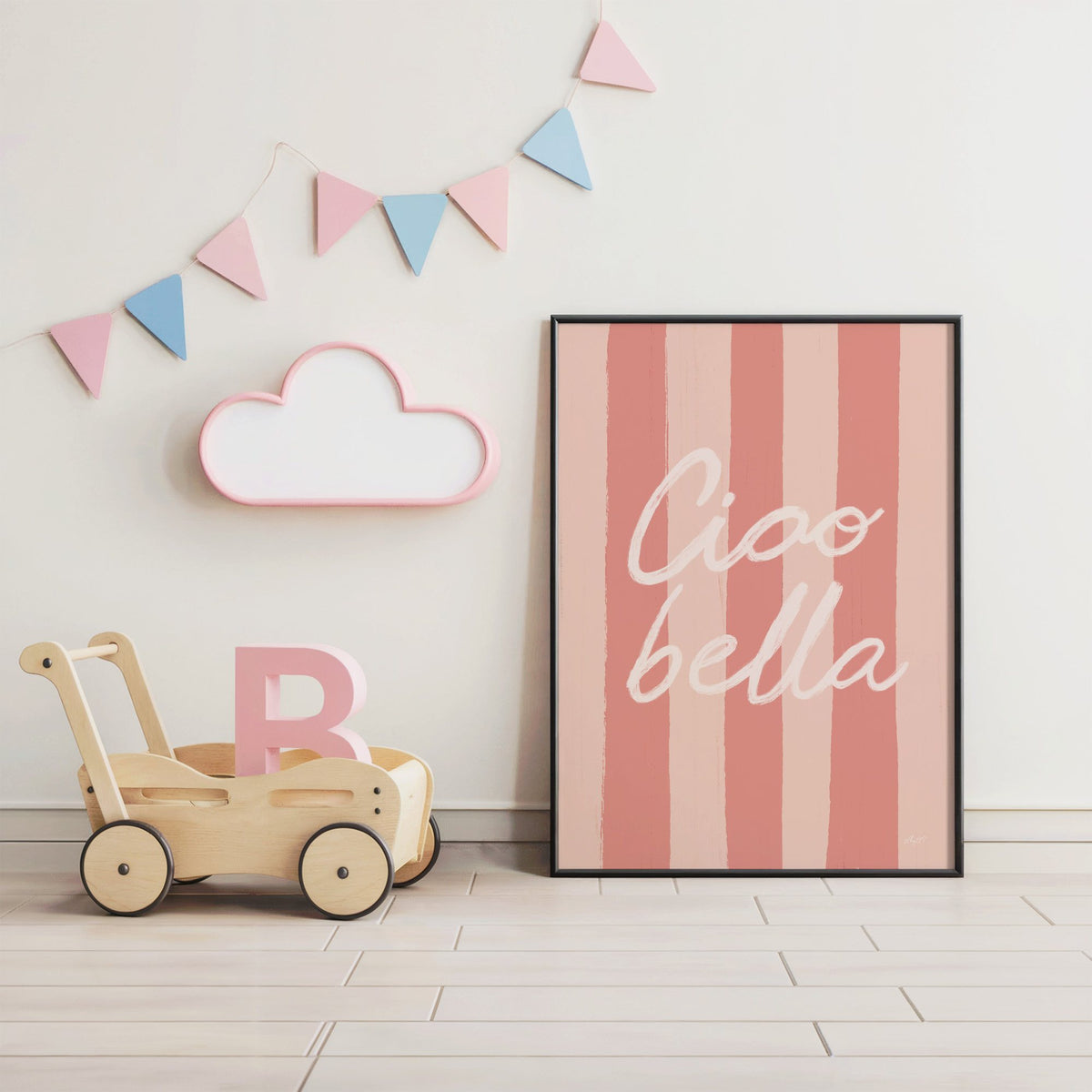 Ciao bella script on pink stripes nursery print in a black frame under pastel bunting by a wooden baby walker