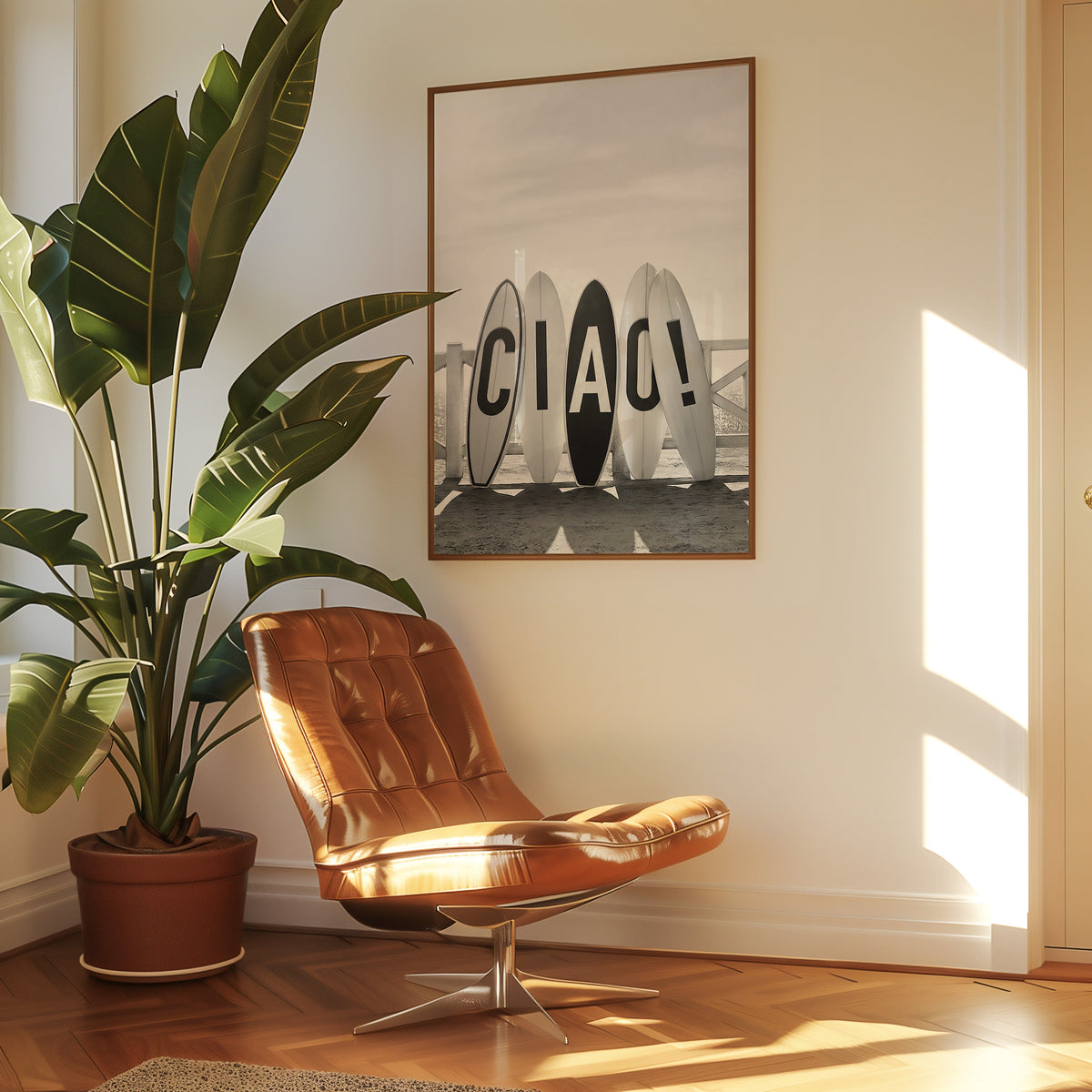 Five surfboards spelling CIAO by a beach fence print in a walnut frame above a leather lounge chair