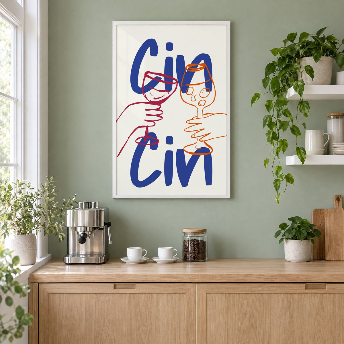 Cin Cin cobalt blue toast print in a white frame on a sage green coffee nook wall above an espresso machine
