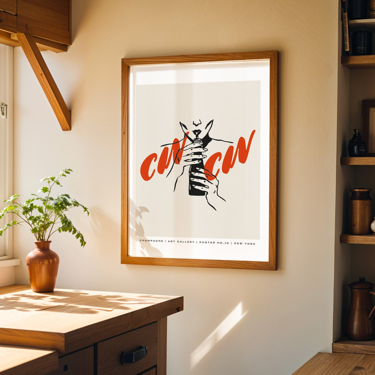 Cin Cin champagne print in a walnut frame on a cream kitchen wall above the island