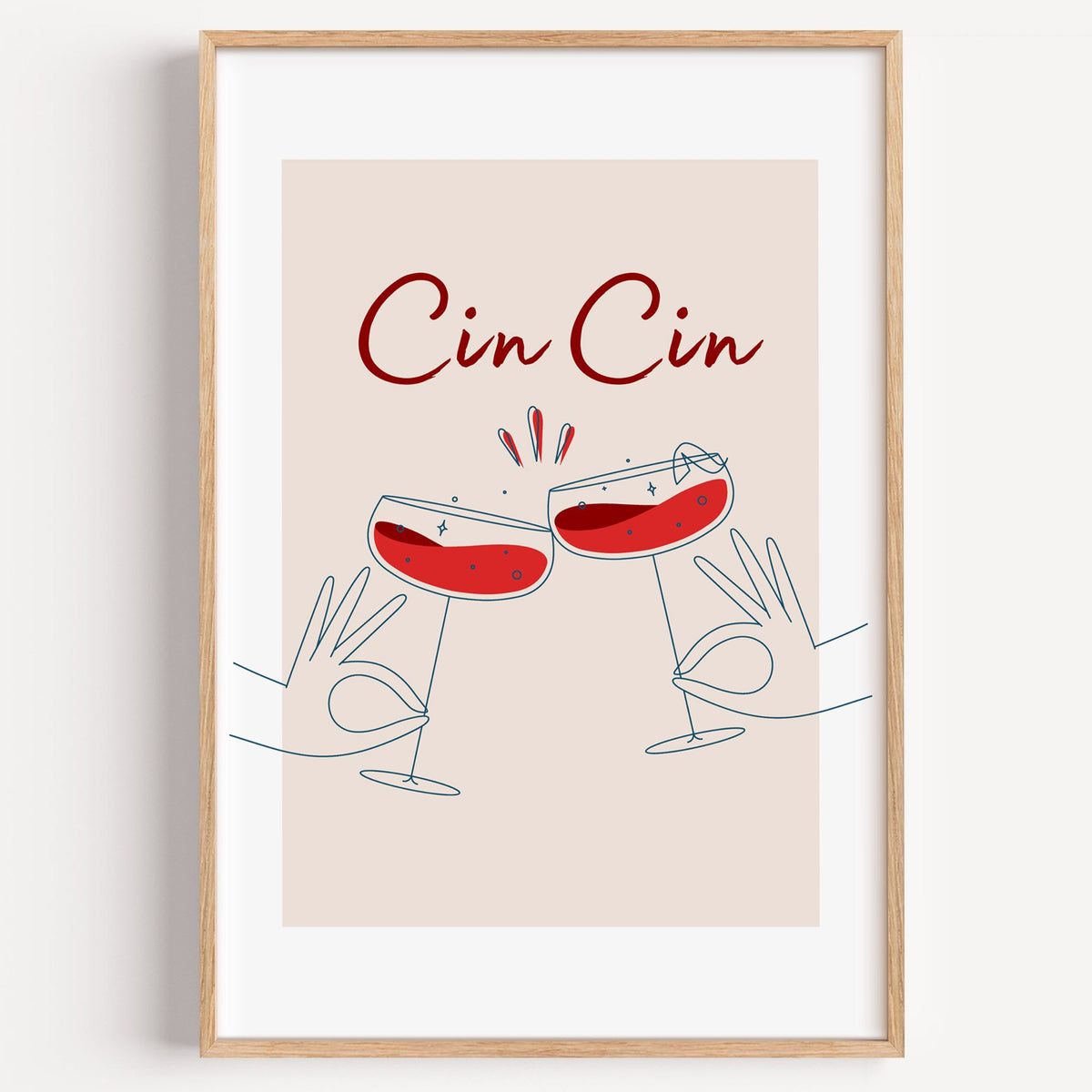 Cin Cin script two hands clinking red coupes print in a light oak frame on a plain white wall