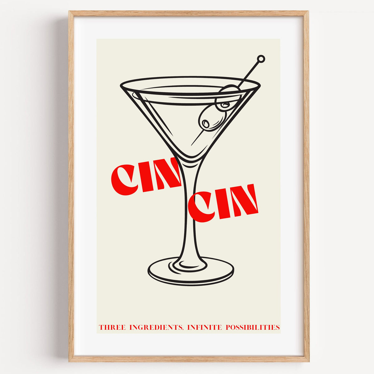 CIN CIN red type martini olives print in a light oak frame on a plain white wall