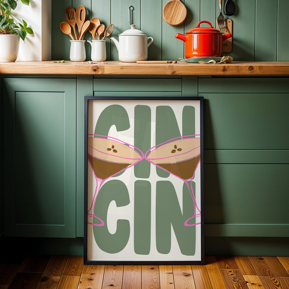 Cin cin espresso martini print in a black frame against sage green cabinets