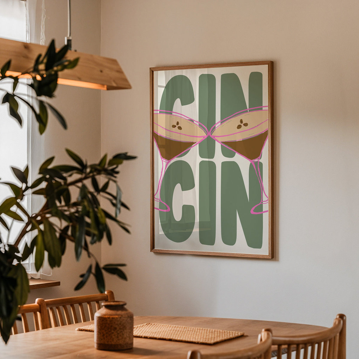 Cin cin espresso martini print in a walnut frame by a dining table and olive tree