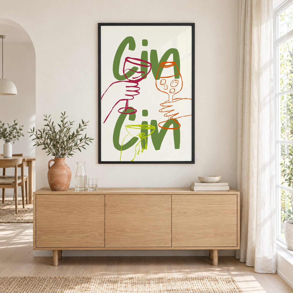 Cin Cin olive green three glasses print in a black frame above an oak sideboard with a terracotta vase of olive branches