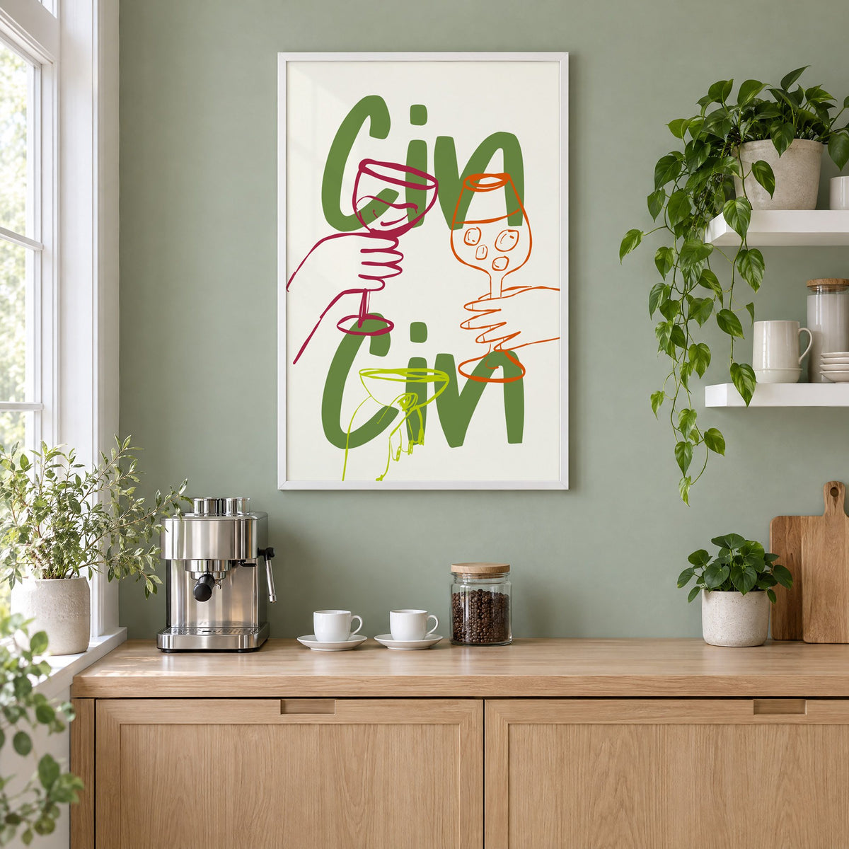 Cin Cin olive green three glasses print in a white frame on a sage green coffee nook wall above an espresso machine