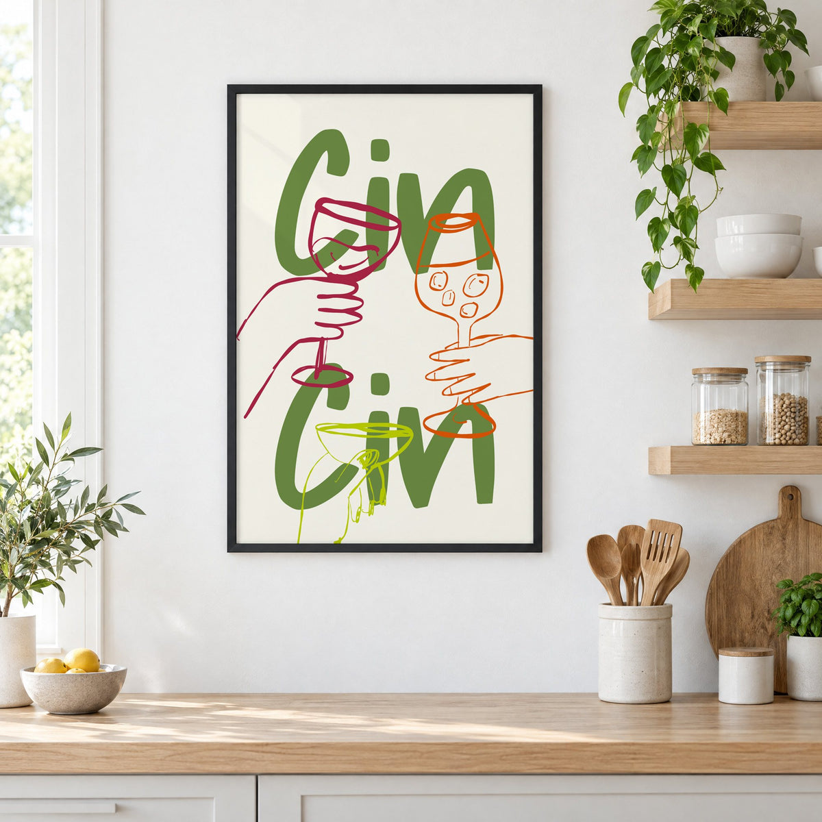 Cin Cin olive green three glasses print in a black frame in a white kitchen beside open wood shelves and glass jars