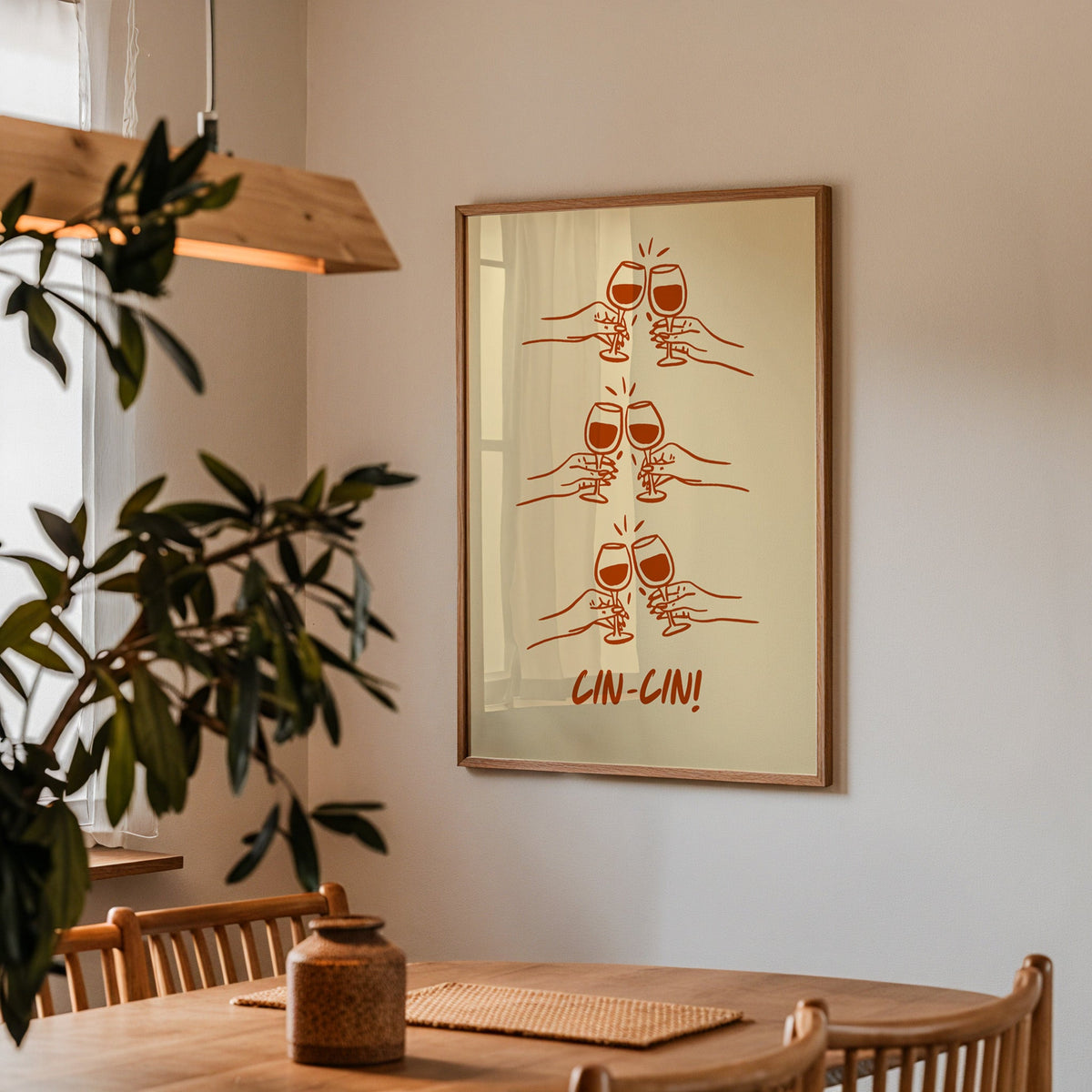 Cin Cin toasting hands print in a walnut frame above a dining table with olive branches