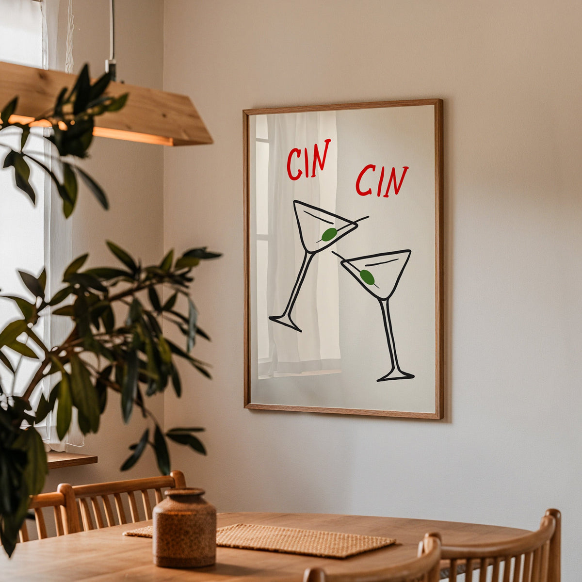 Cin cin olive martini print in a walnut frame by a dining table and olive tree