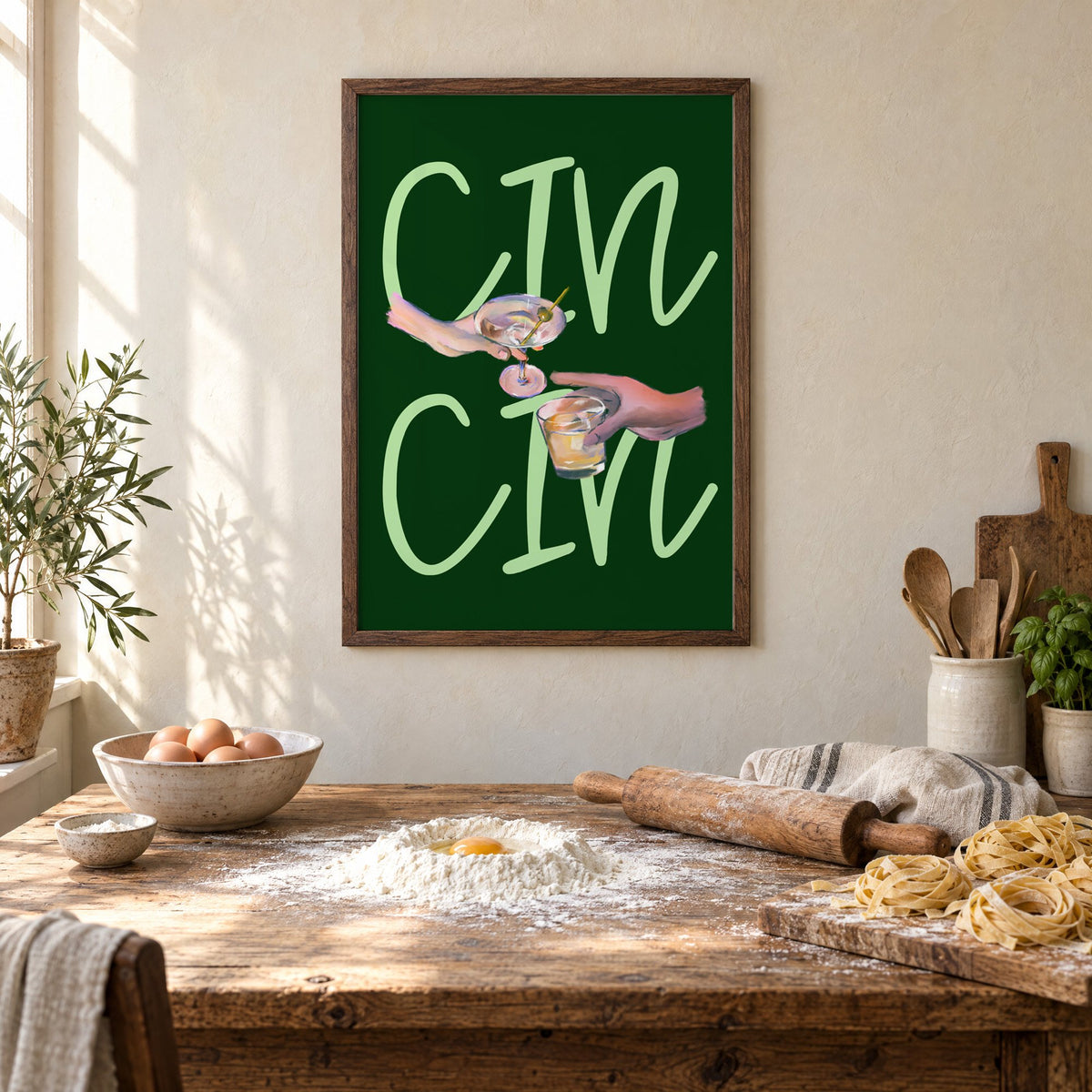CIN CIN martini and whiskey toast print in a walnut frame above a rustic table set for making fresh pasta