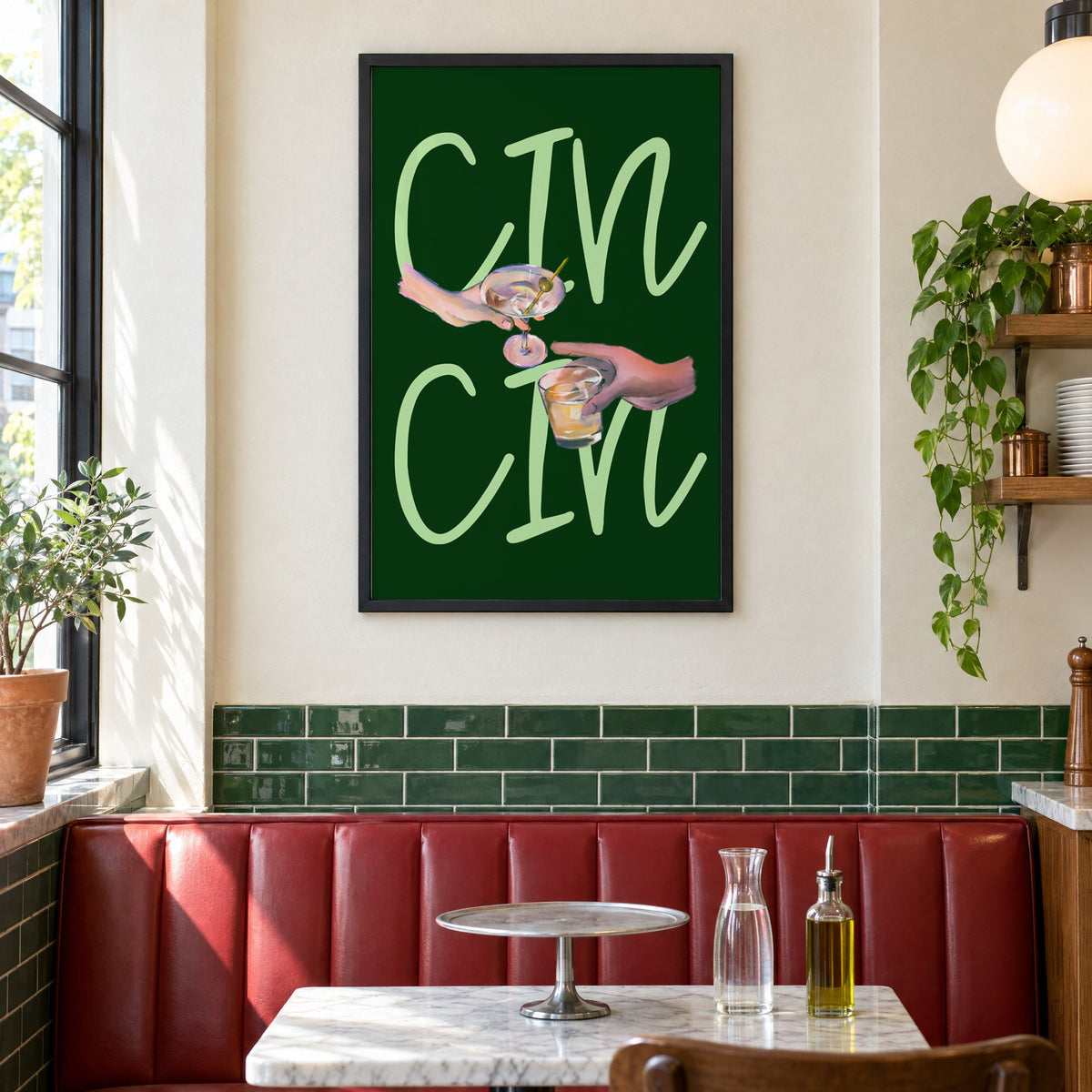 CIN CIN martini and whiskey toast print in a black frame above a red leather booth in a sunny pizzeria