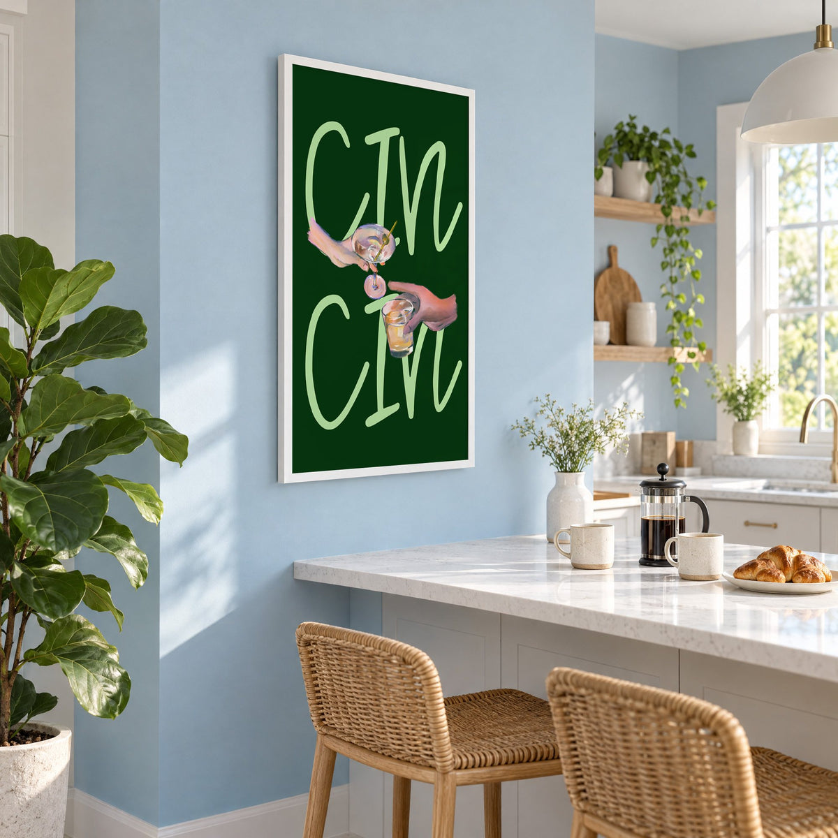 CIN CIN martini and whiskey toast print in a white frame on a pale blue wall above a breakfast bar with rattan stools