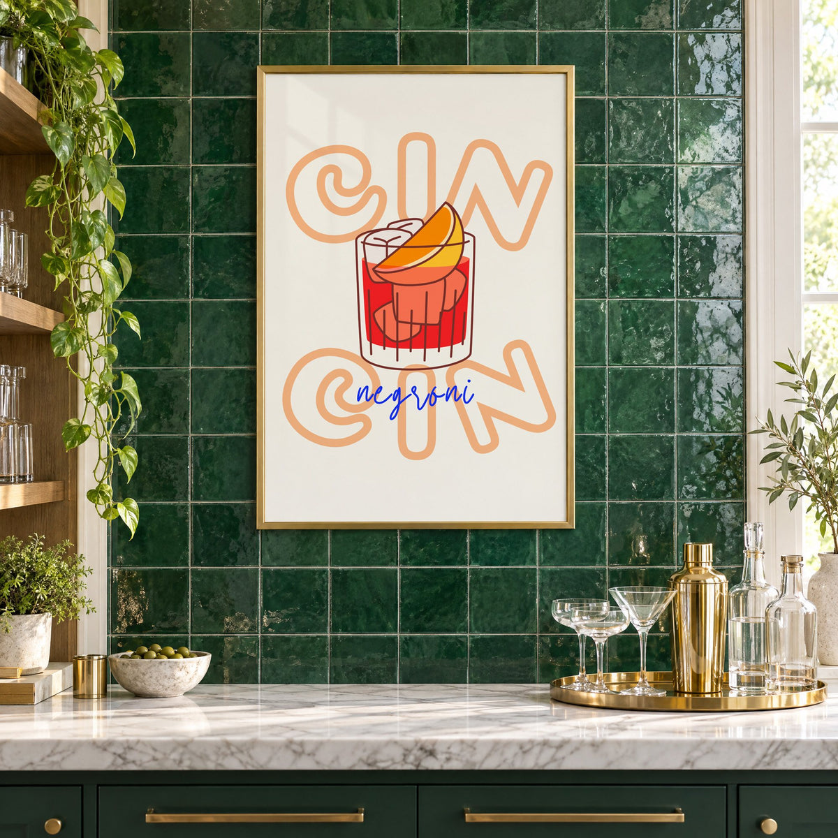 Cin Cin negroni orange slice print in a brass frame on emerald green tiles above a home bar with coupe glasses