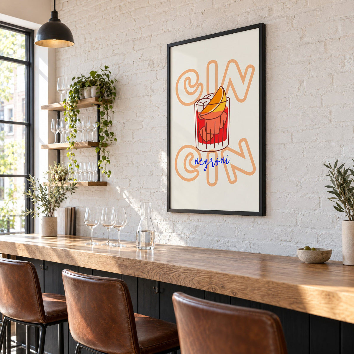 Cin Cin negroni orange slice print in a black frame on a white brick wall above a wine bar counter